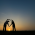 Creating a heart between two people at sunset